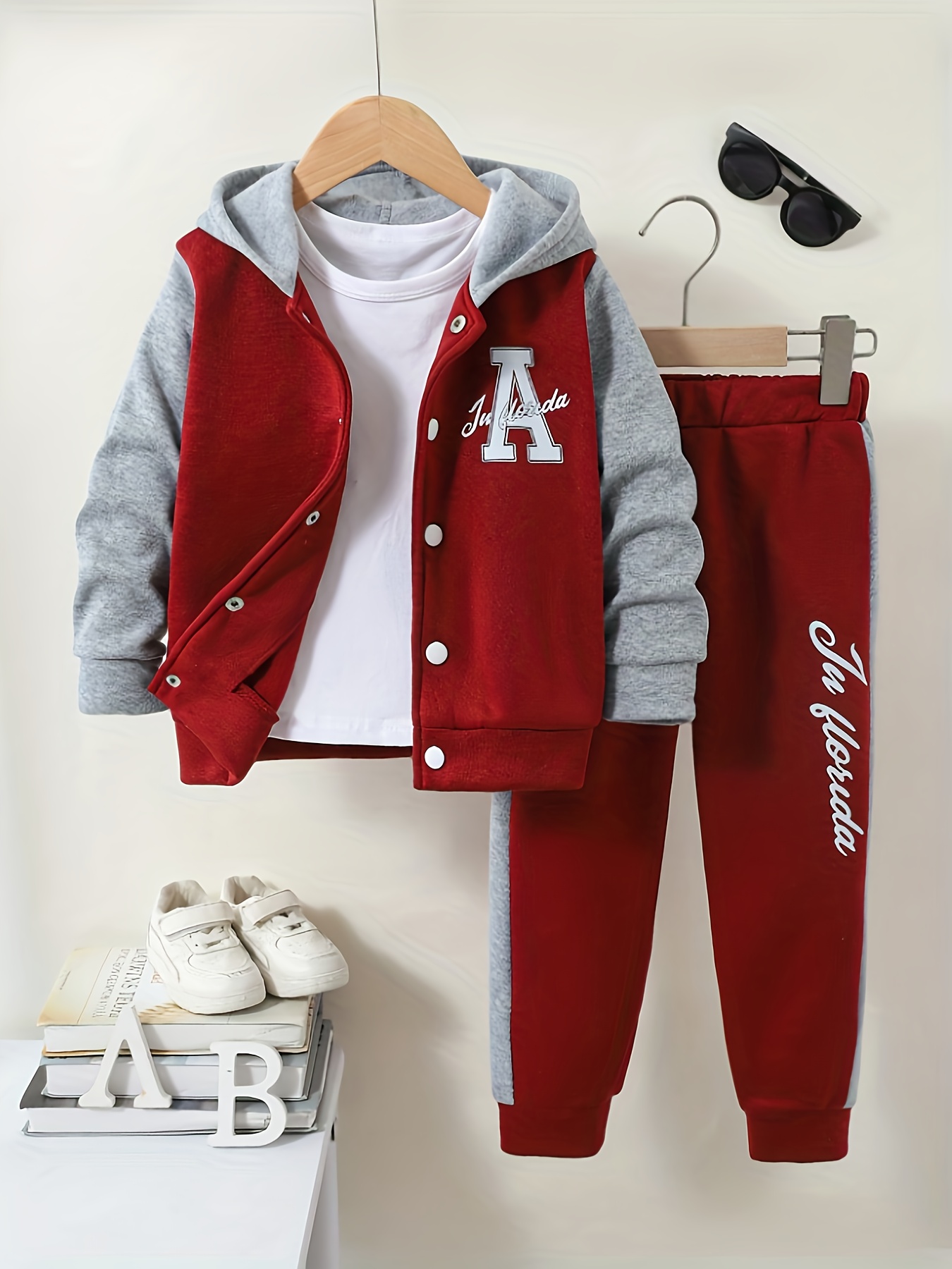 A Two-Piece Set for Boys Featuring a Hooded Baseball Jacket with a Faux Layered Color Design And Matching Long Pants. It Has Letter Pattern Prints, Showcasing a Stylish And Casual Style, Making It a Comfortable And Trendy Sports Outfit for Autumn An